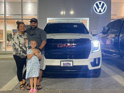 family with GMC white truck