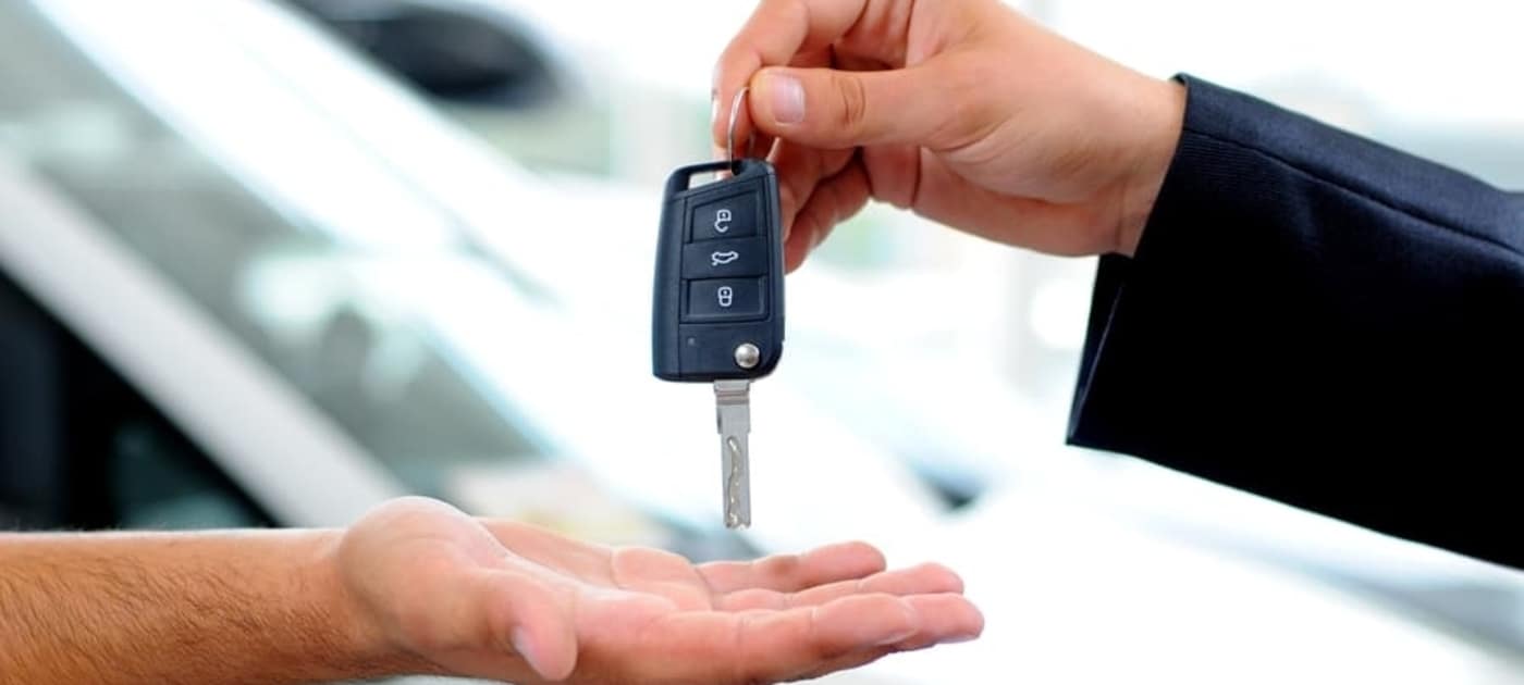 car-salesman-passing-key