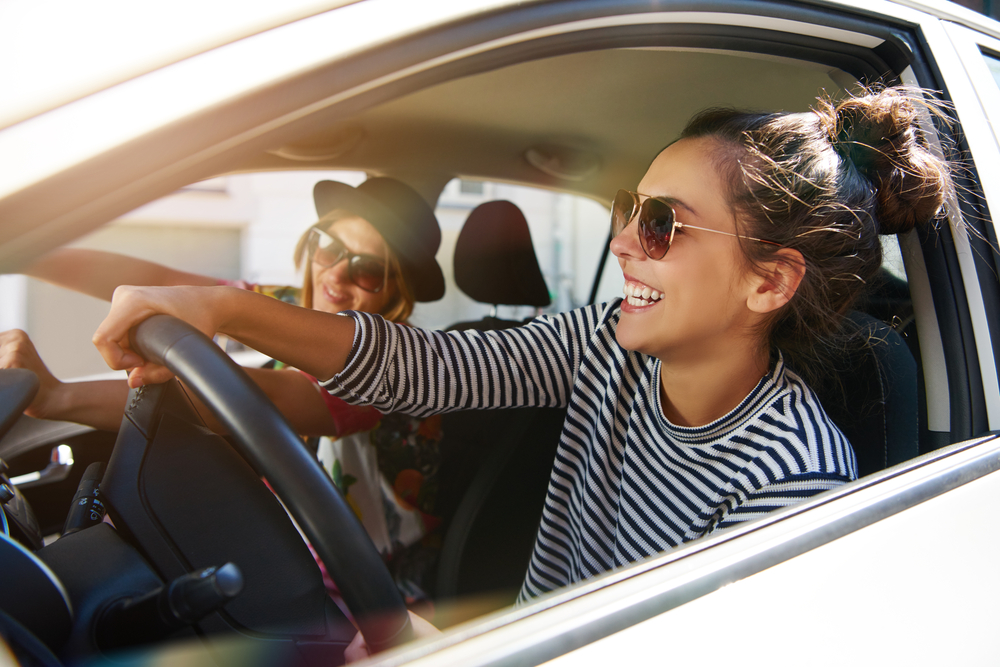 Two young women enjoying driving near Weatherford, TX